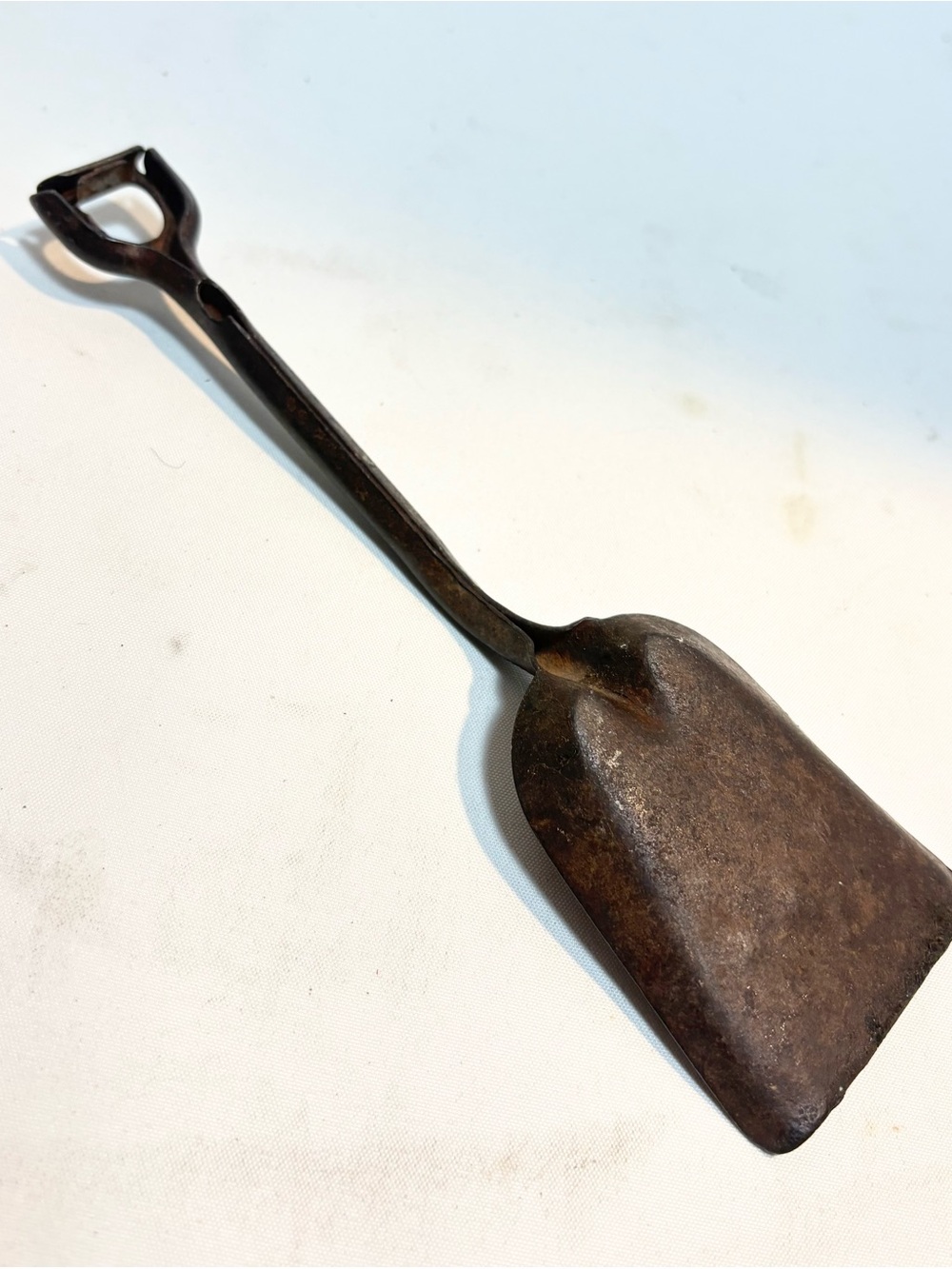 a vintage cast iron hand-made toy shovel 8”